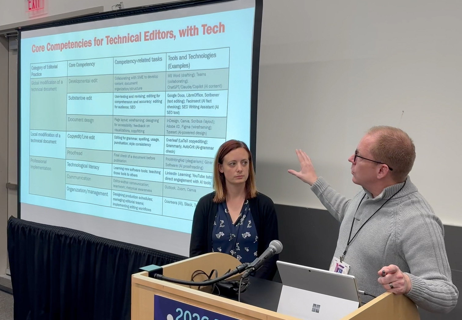 Both presenters explaining the core competencies for technical editors by referring to a table slide.